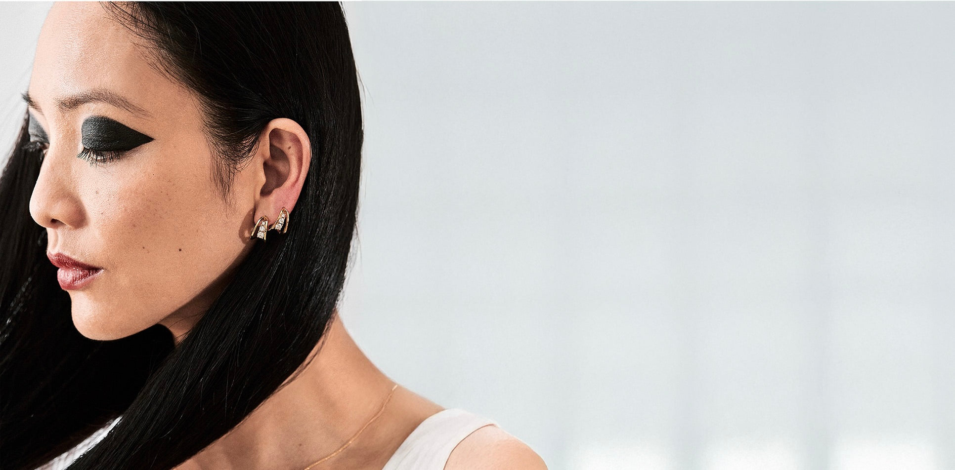 Stylish earrings featuring a gold hoop design with a decorative light blue stone and sparkling accents, perfect for everyday wear or special occasions. Earrings collection.