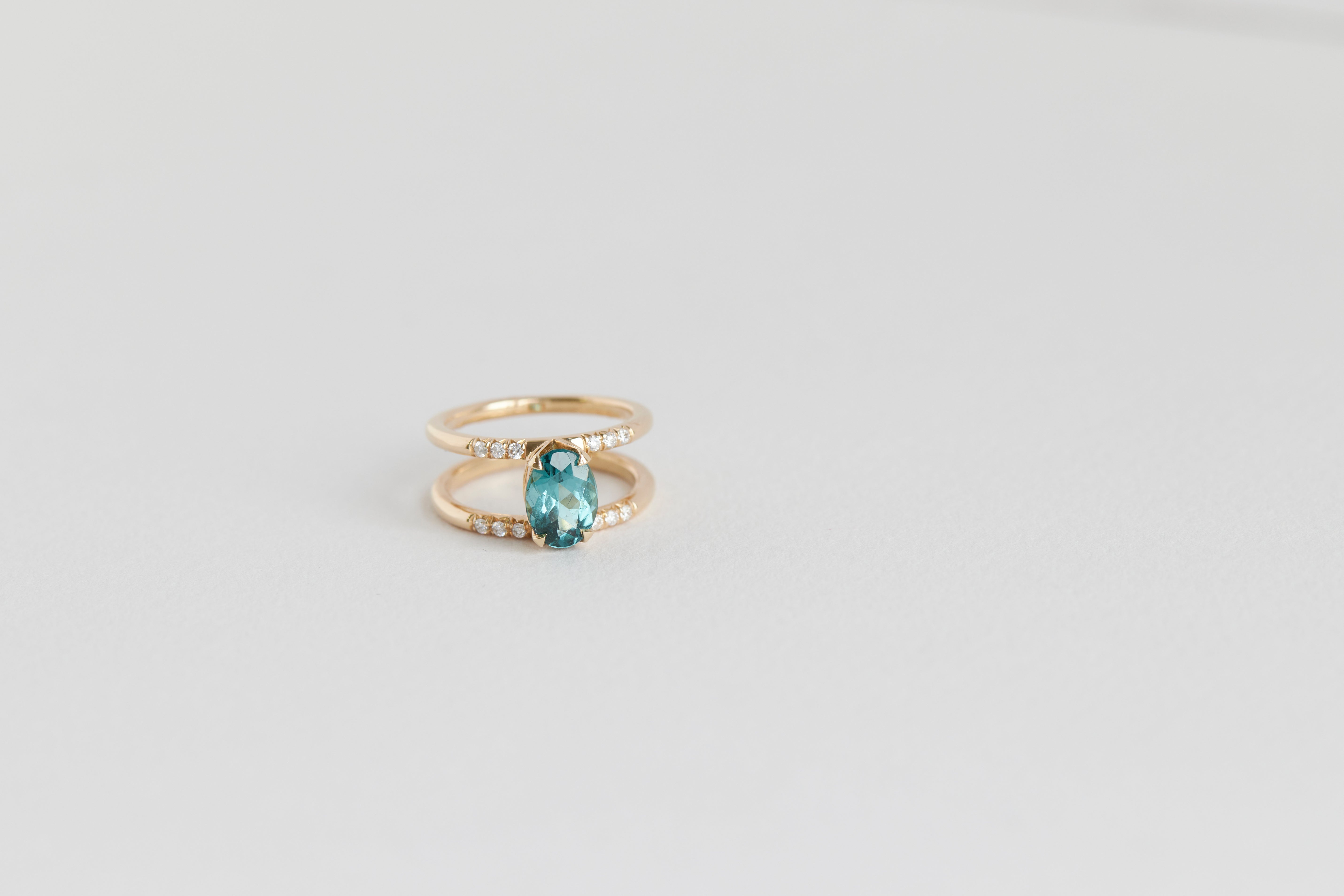 Illuminate Engagement Ring from Signature Collection featuring a stunning teal gemstone, elegantly set in a double-band design, symbolizing sophistication and charm.