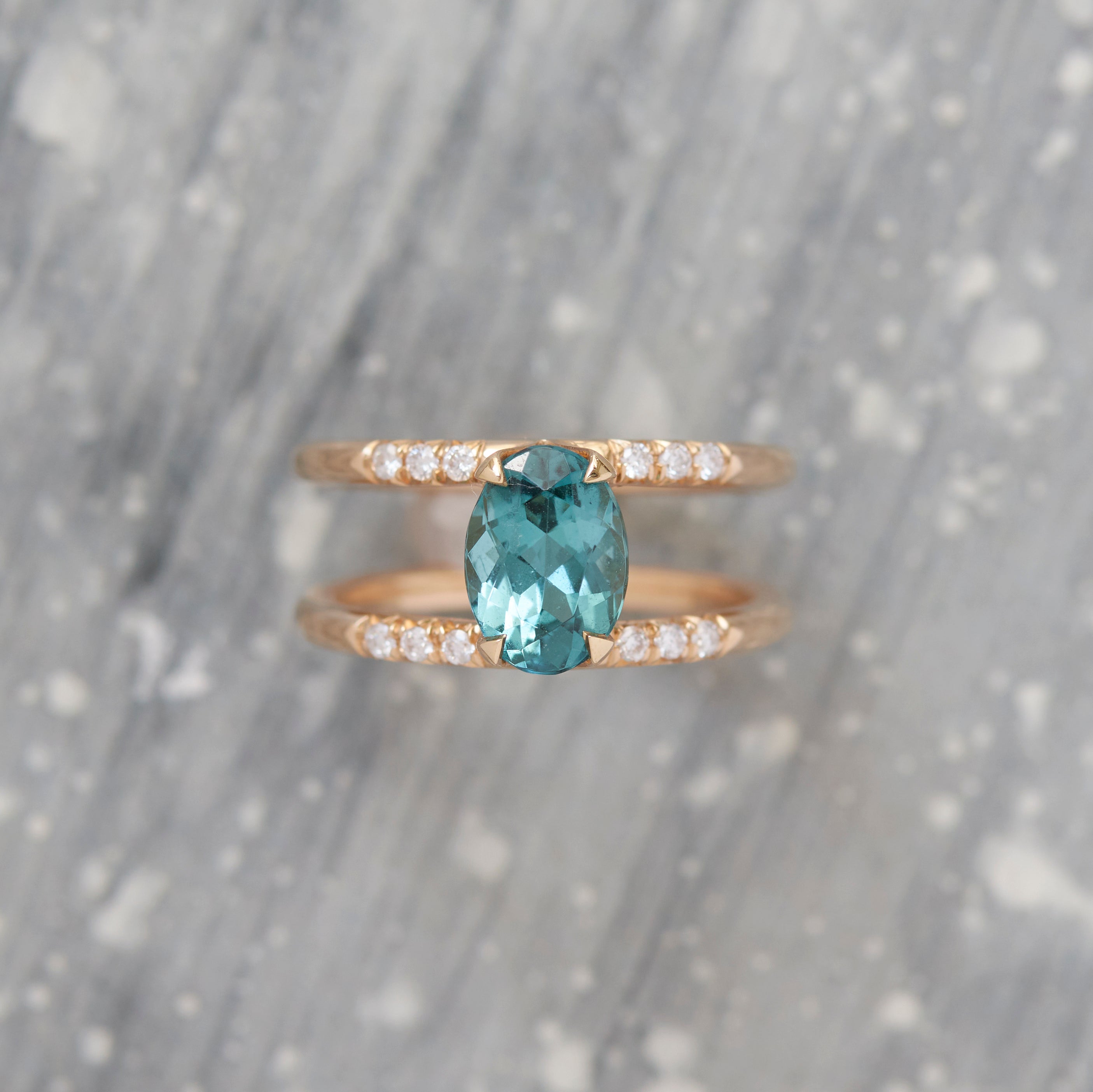 Illuminate Engagement Ring Signature Collection showcasing an exquisite oval natural light blue sapphire in rose gold, complemented by sparkling pave set white diamonds, symbolizing elegance and luxury.