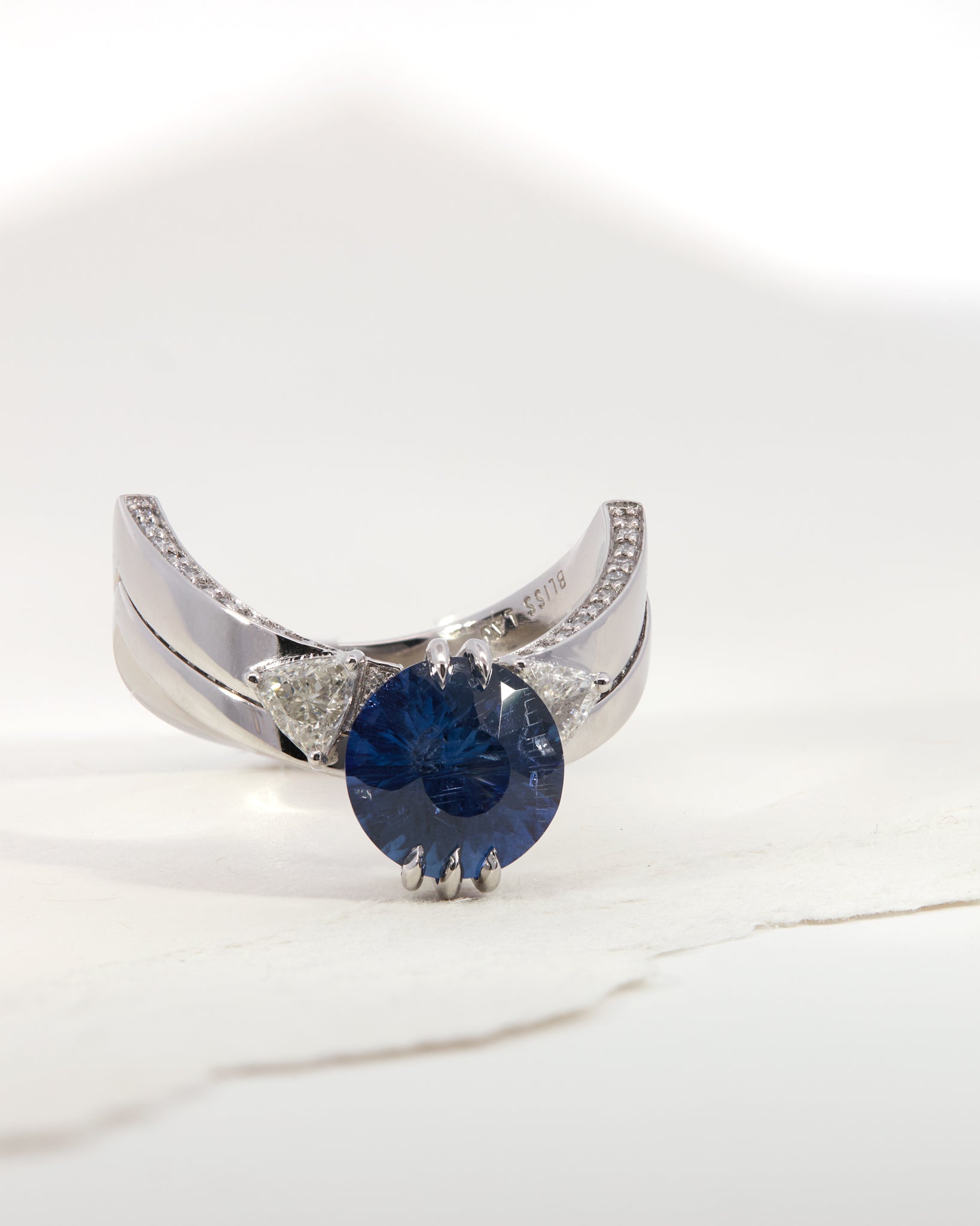 Sphynx Platinum and Blue Sapphire Ring featuring a stunning deep blue round sapphire centerpiece and intricately set natural diamonds, showcasing luxury and elegance in a unique two-piece design.