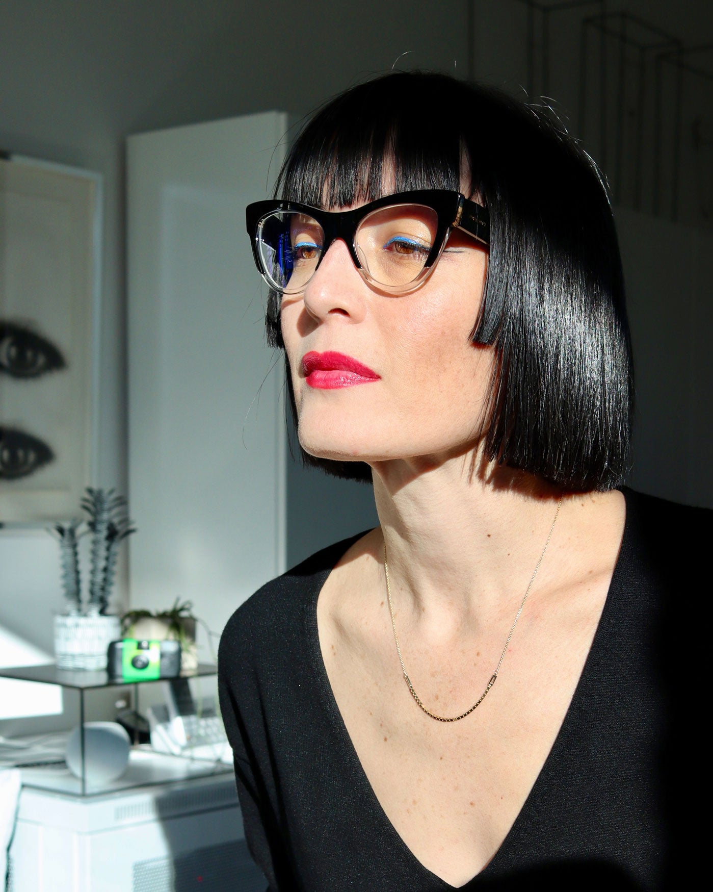 Bliss Lau wearing the Halo Luna Necklace is a combination of interlick chain and box chain with the box chain hanging perfectly centered and two lab diamond baguettes on either side. while staring into her window