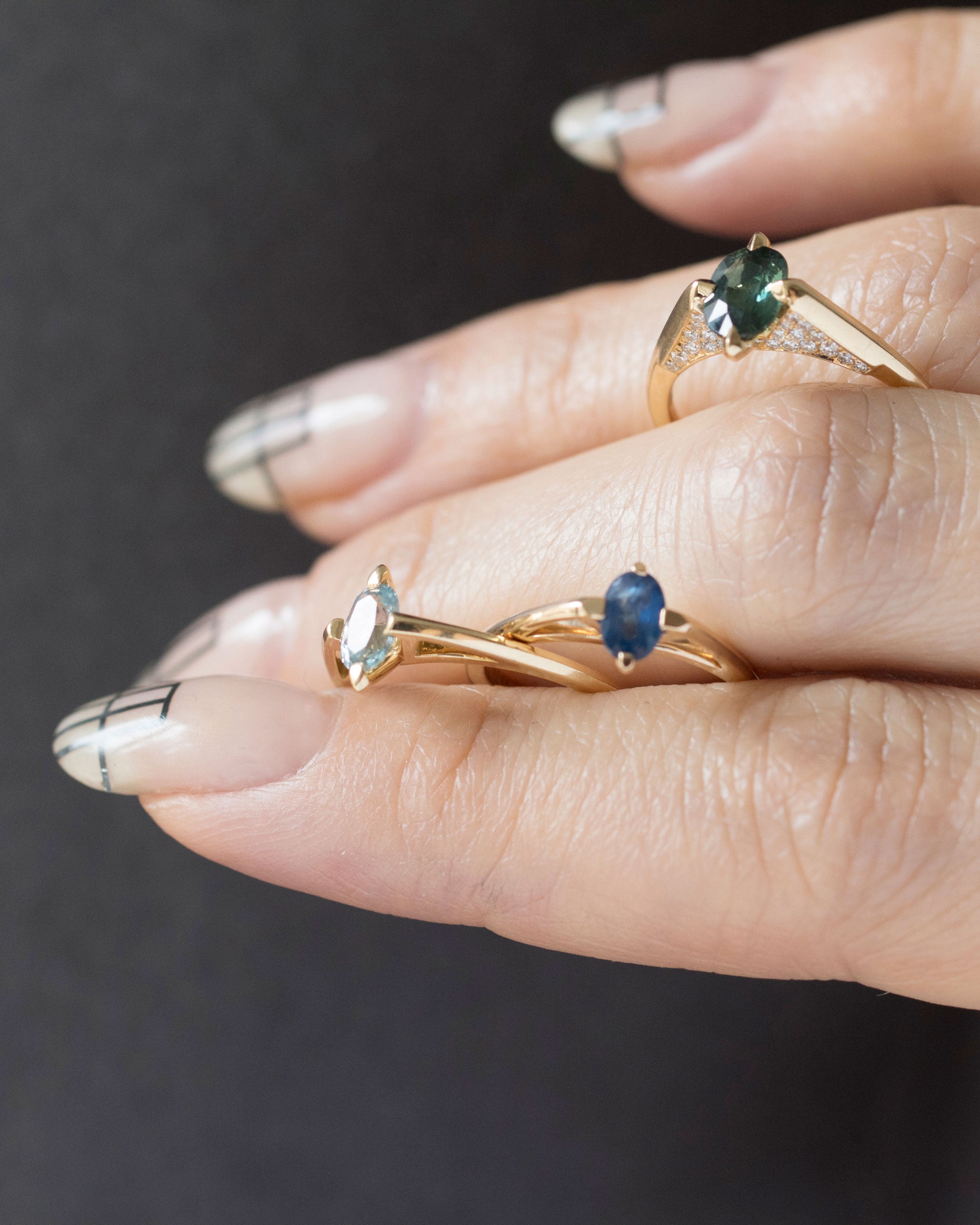 An elegant minimalist gold ring showcased with gemstones, embodying Bliss Lau's artistic vision of the minimalist arc, minimalist rise, and minimalist pave.