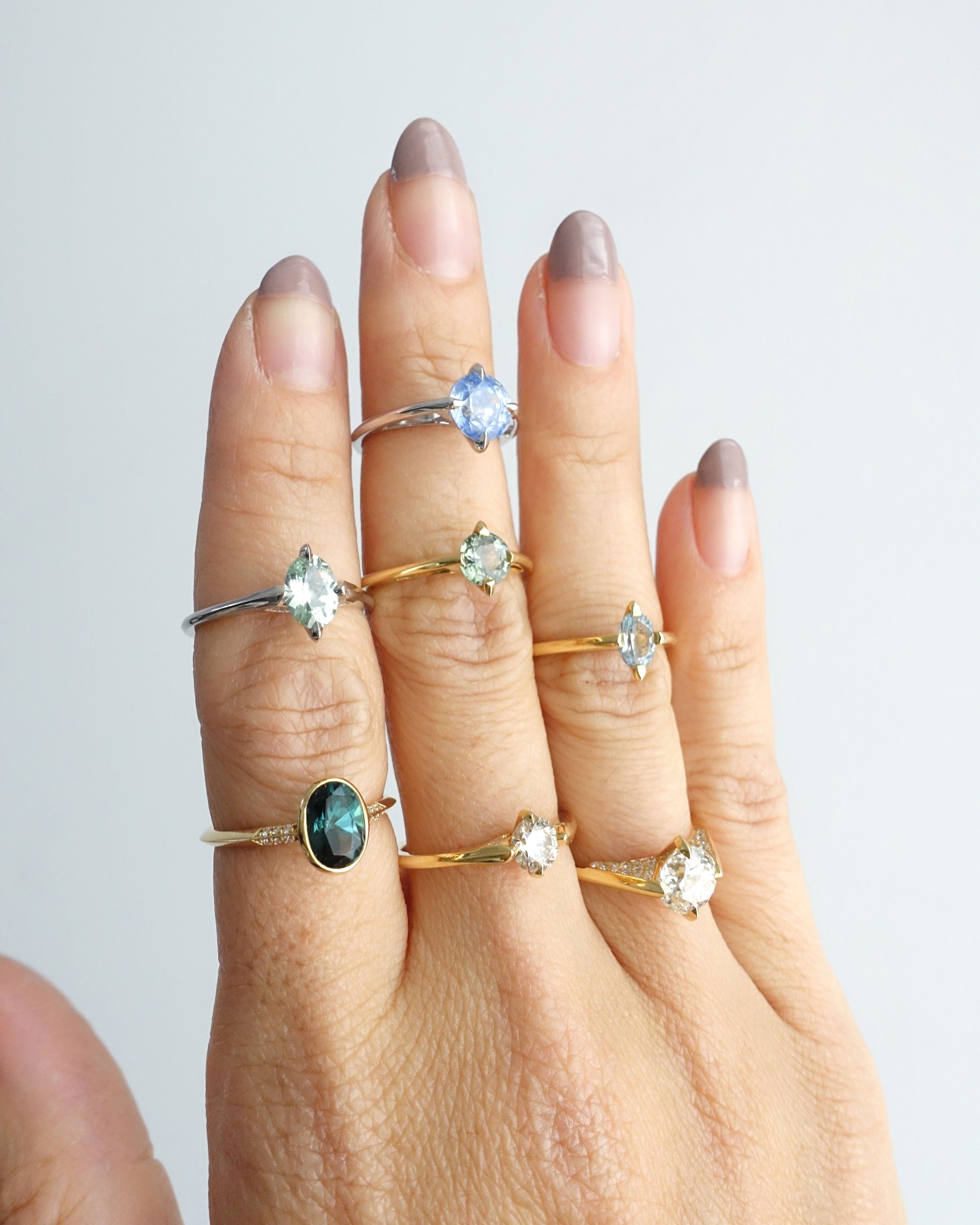 A stunning minimalist gold ring displayed against a neutral background, highlighting the craftsmanship of Bliss Lau's minimalist arc, minimalist rise, and minimalist pave.