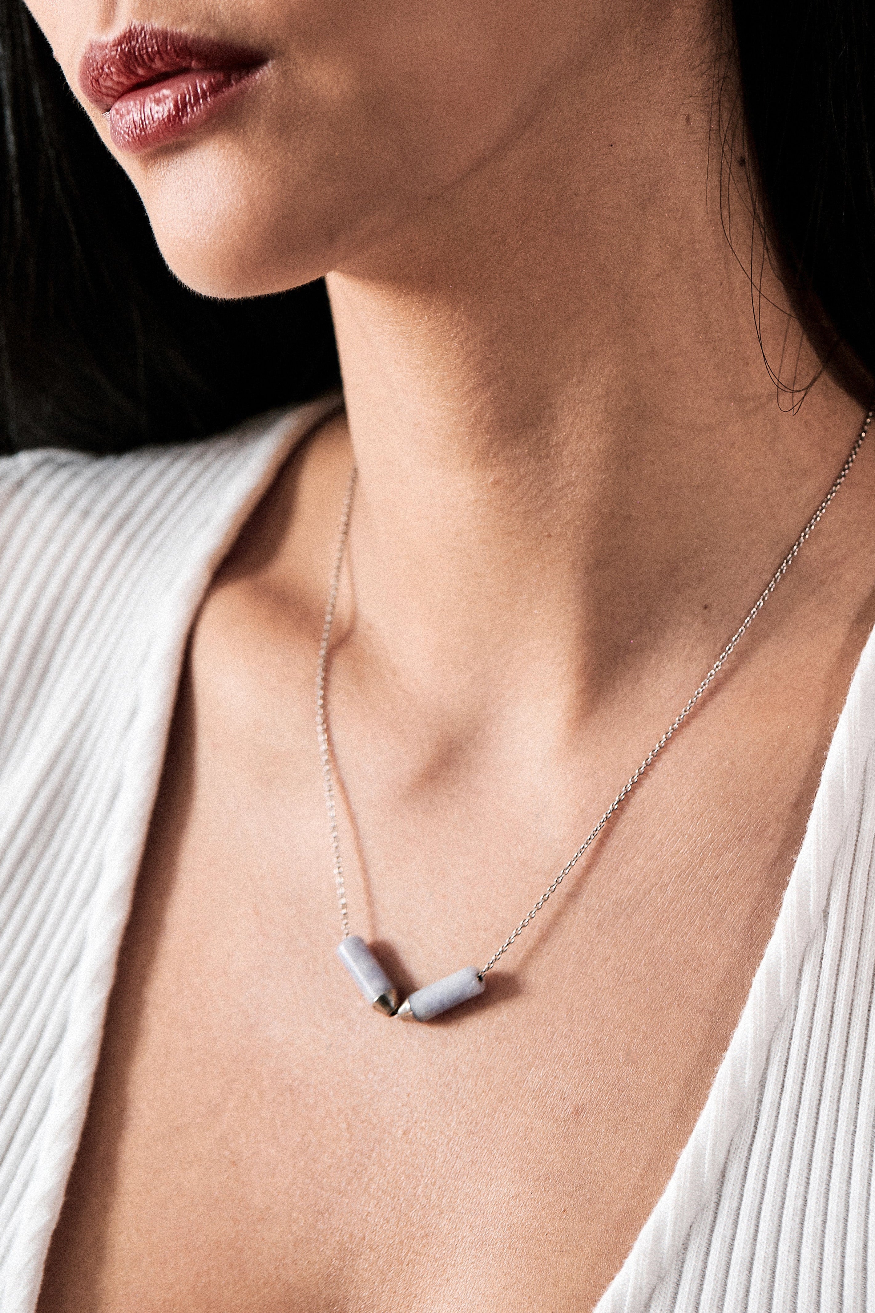 Close-up of a model wearing the Open Necklace - Mayan Lavender Jade and Platinum, highlighting the elegant clasp and the exquisite lavender jade detailing against a soft backdrop.