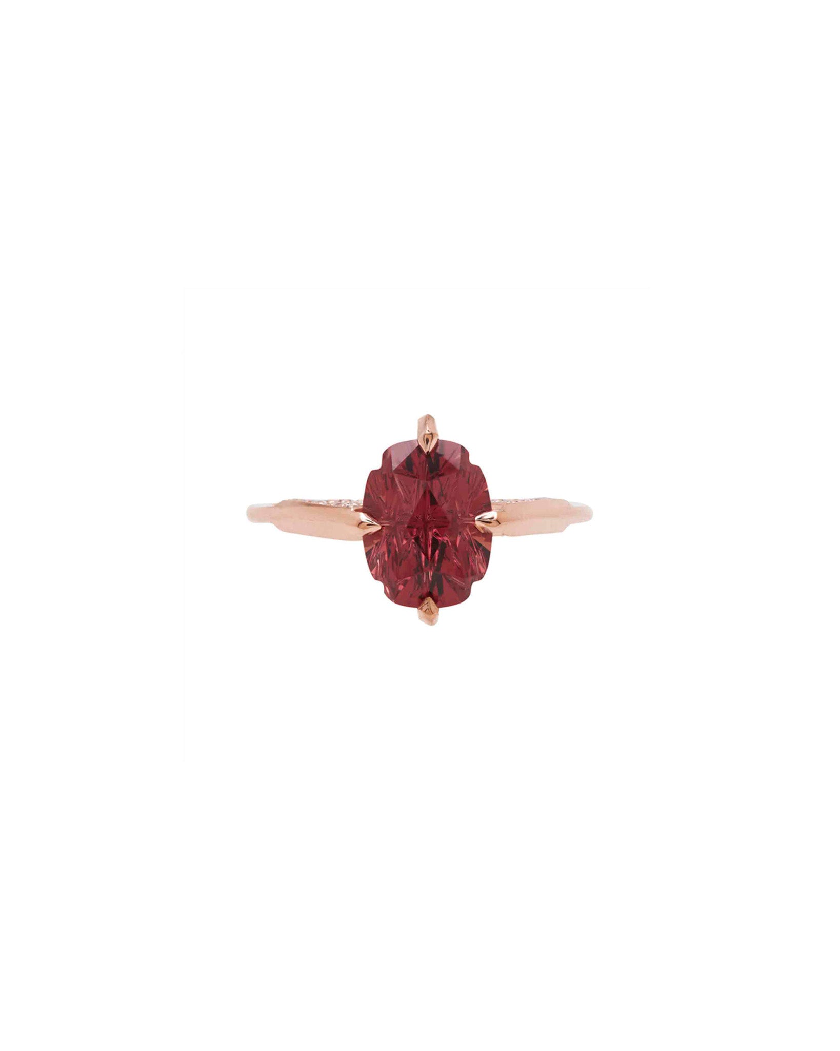 A stylish minimalist gold ring highlighted next to a metallic surface, showcasing the refinement in design of Bliss Lau's minimalist arc, minimalist rise, and minimalist pave.