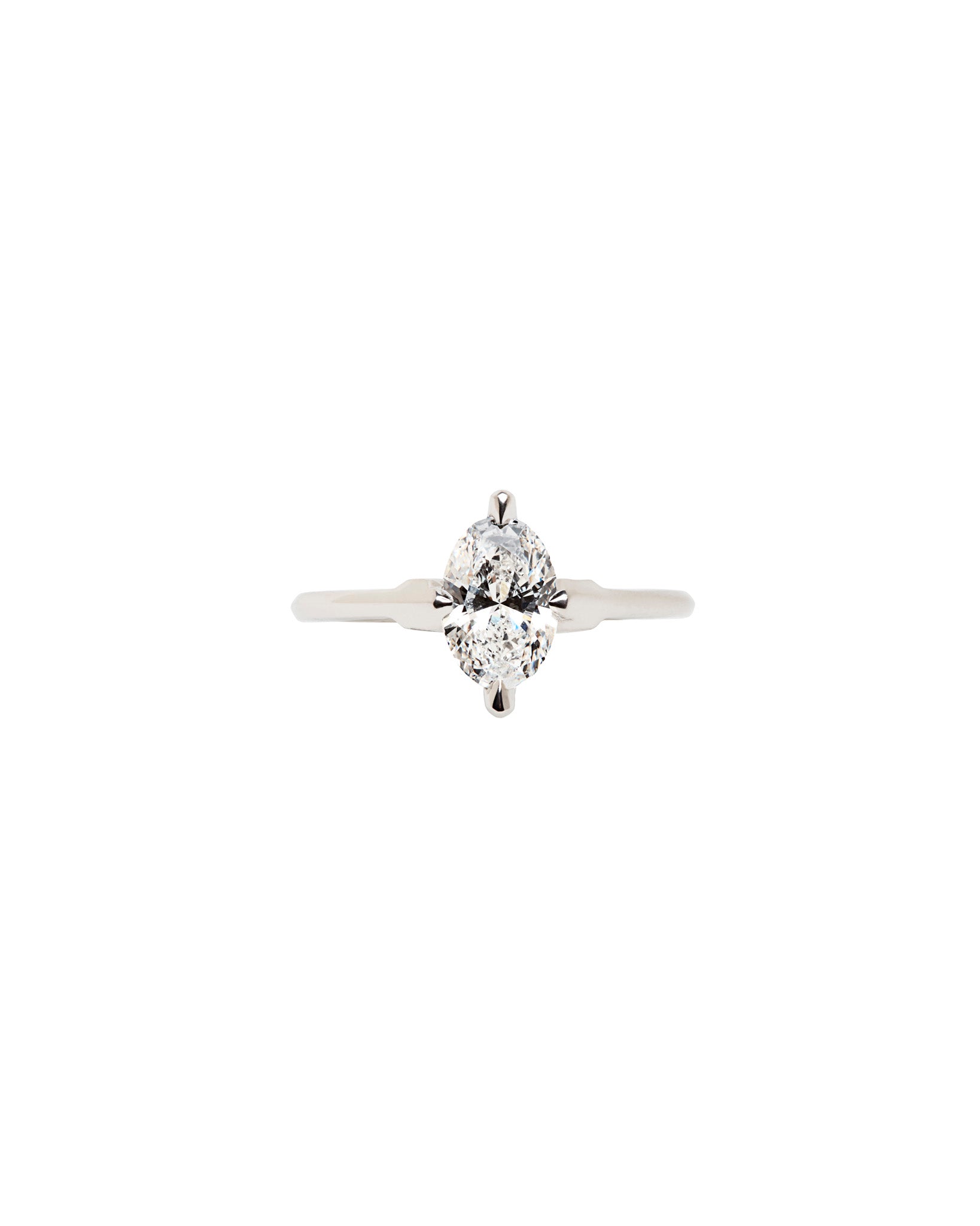 A captivating minimalist gold ring rests on a surface, showcasing the aesthetic of Bliss Lau’s minimalist arc, minimalist rise, and minimalist pave designs.
