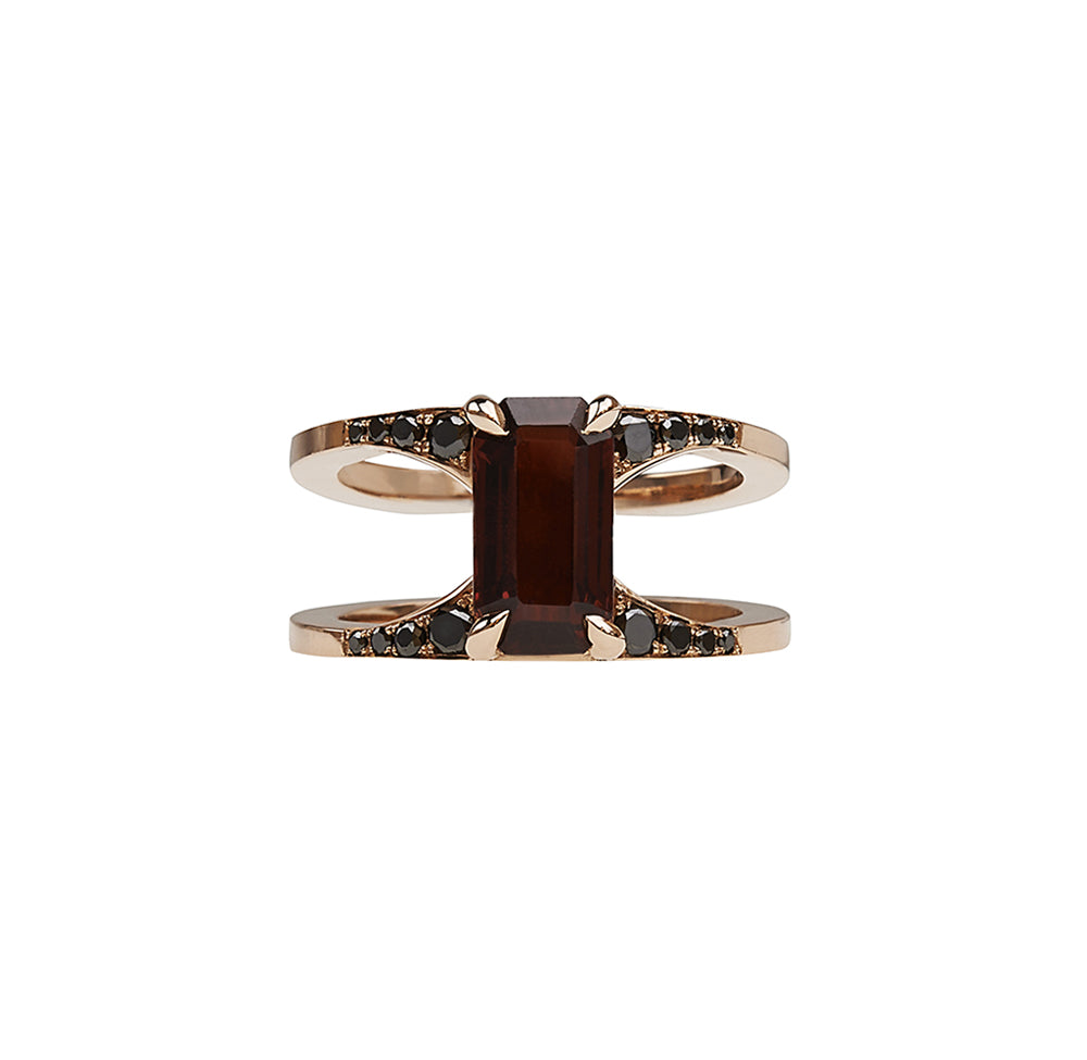 Elegant Mirage Ring from the Signature Collection, featuring a stunning emerald cut garnet center stone surrounded by black diamonds, handcrafted for a luxurious look.