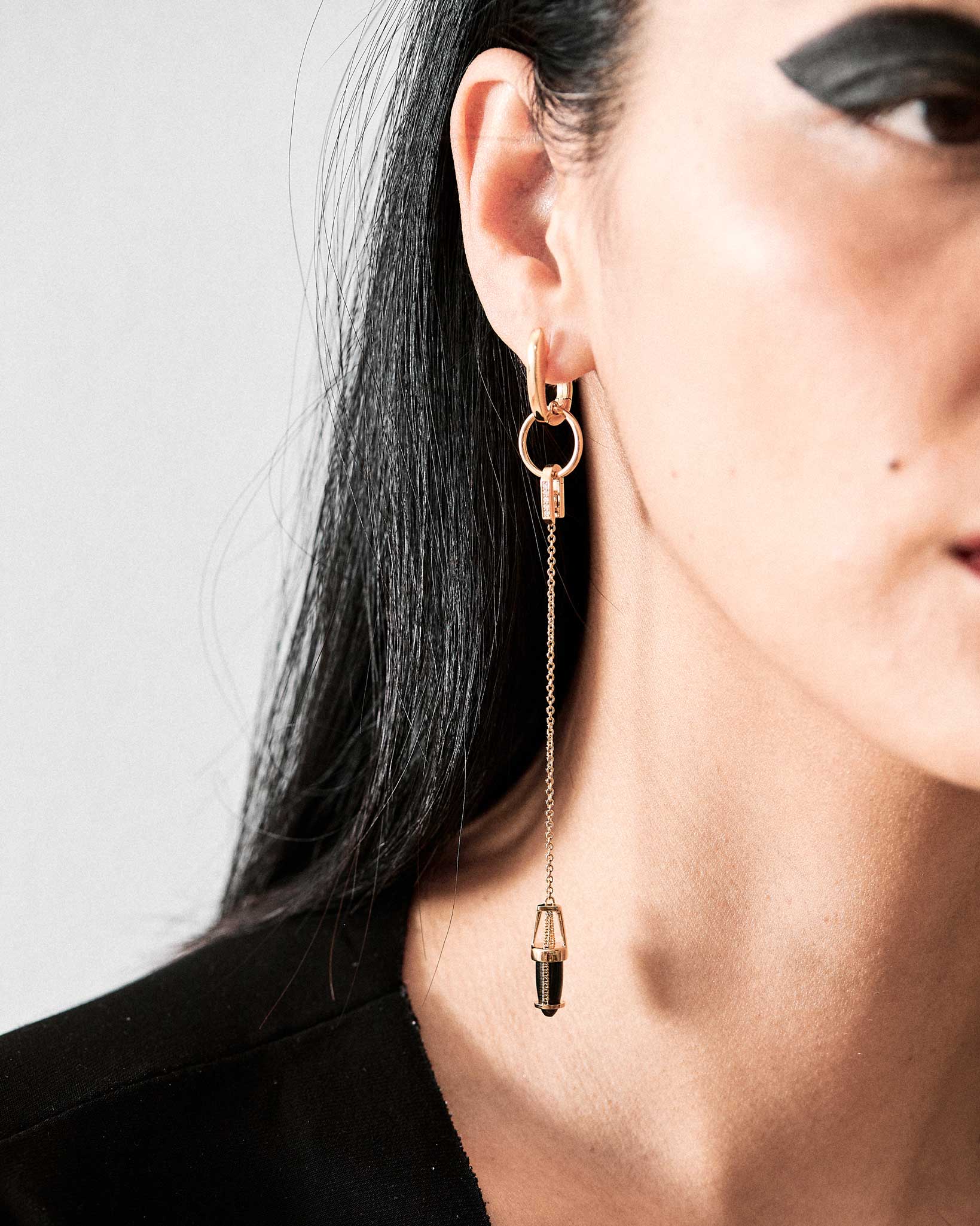 Close-up of the Nuance Hoop + Vantage Curio Earring Set, highlighting the exquisite craftsmanship of the black jade accents suspended from gold hoops.