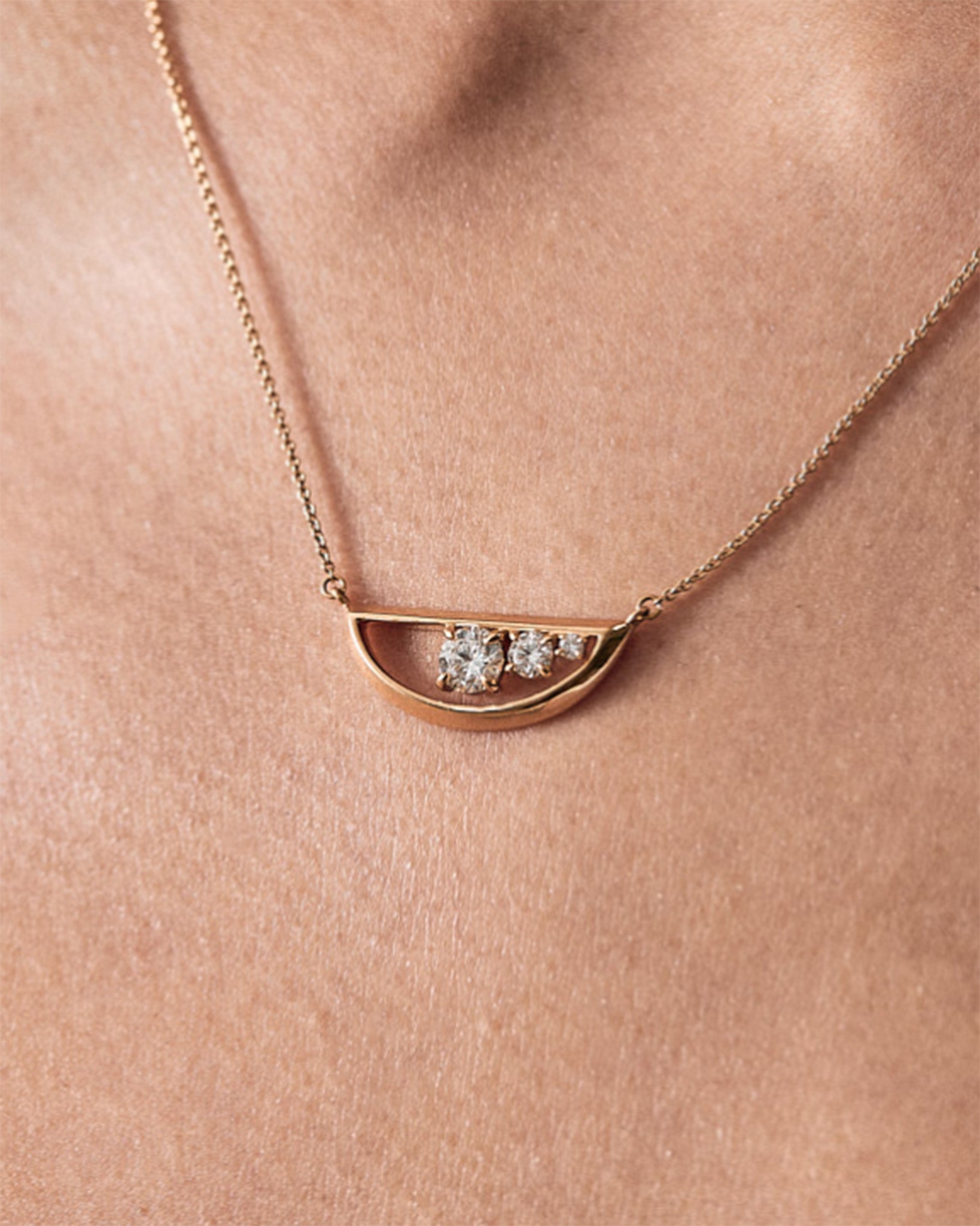 Elegant Empath 18K Gold Necklace adorned with three lab diamonds, showcased on a model's neckline, emphasizing sophistication and timeless beauty.