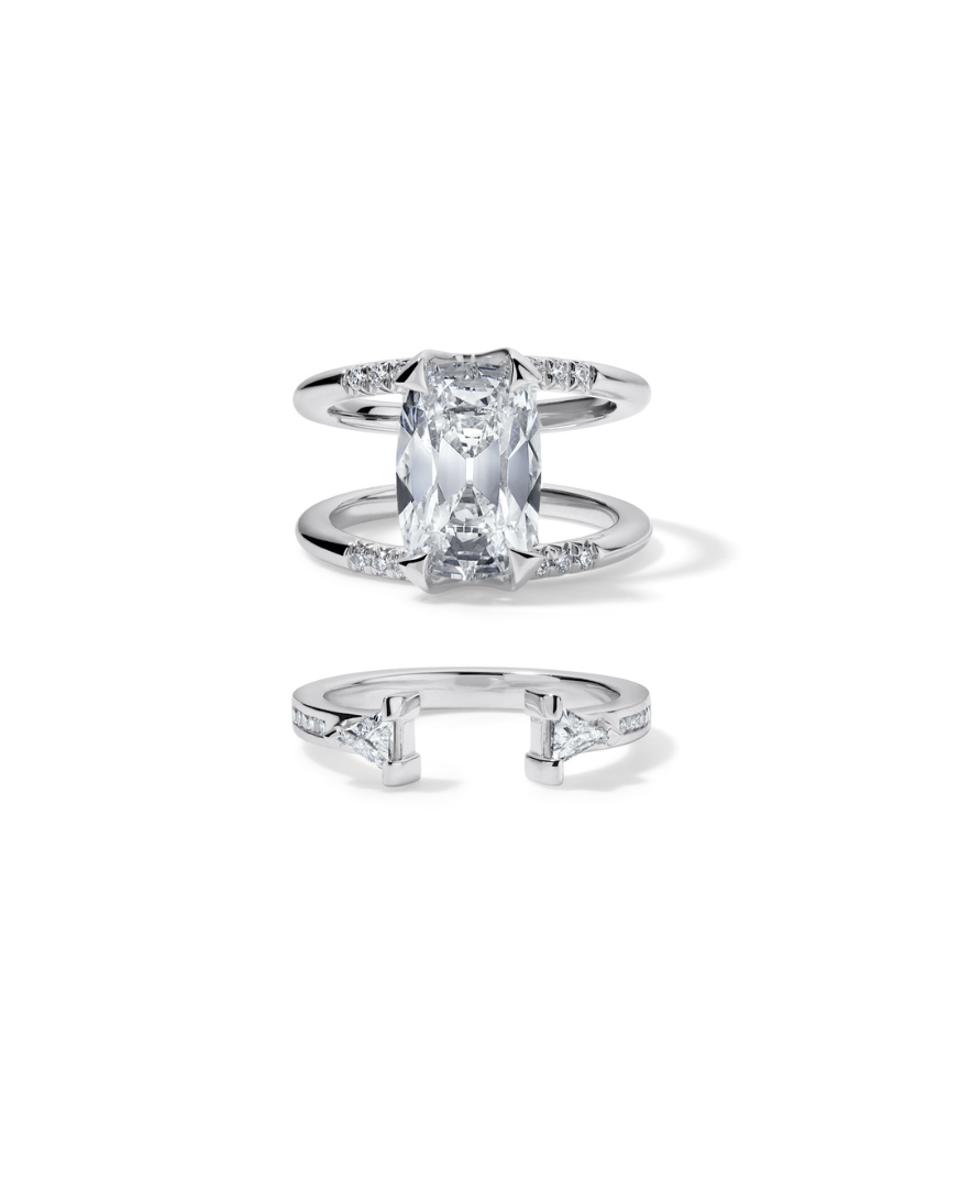 Bliss Lau Illuminate Magnetic Interlocking Ring set in platinum with lab grow diamond. The double-band ring set featuring a lab grown diamond and an open band with matching triangular stones in the bottom ring, shown on a white background.