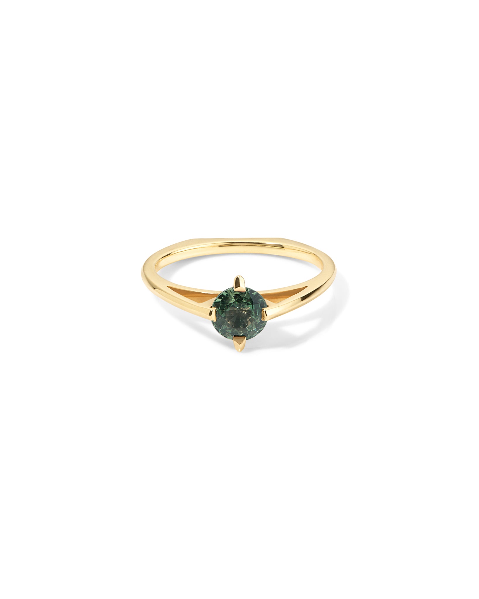 Gold ring with a green sapphire gemstone on a white background