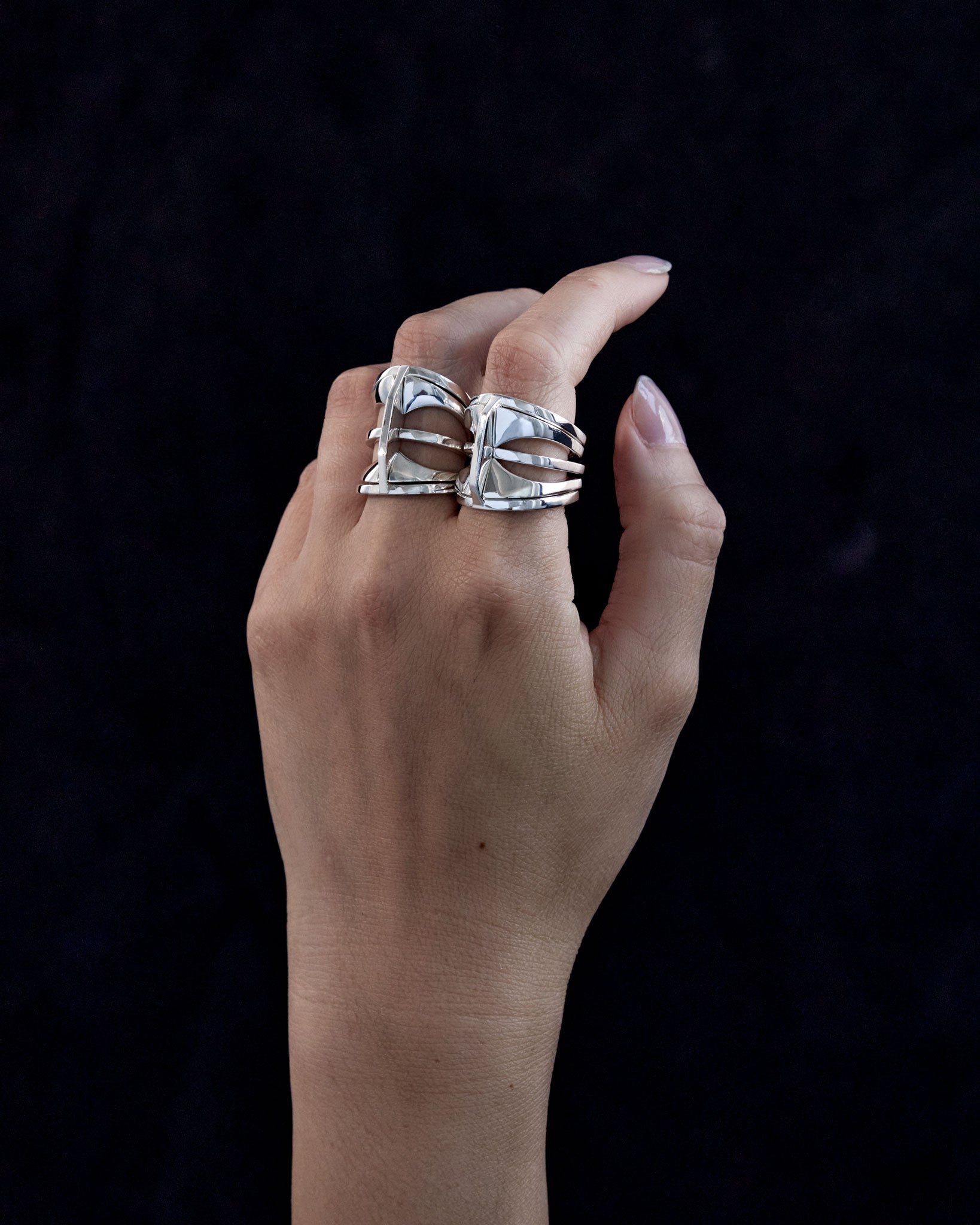 Images comparing the 20mm and 25mm Kaleidoscope rings, showing the difference in size and design aesthetics in shiny sterling silver.