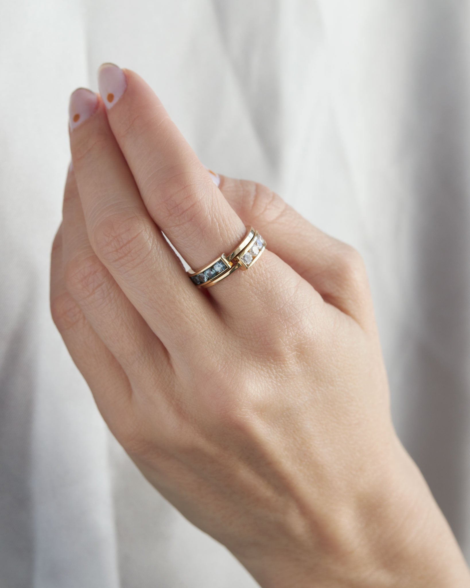 Sophisticated hand featuring the Loyalist Ring - Diamond in a luxurious setting, highlighting the beautiful contrast of gold and gemstones.