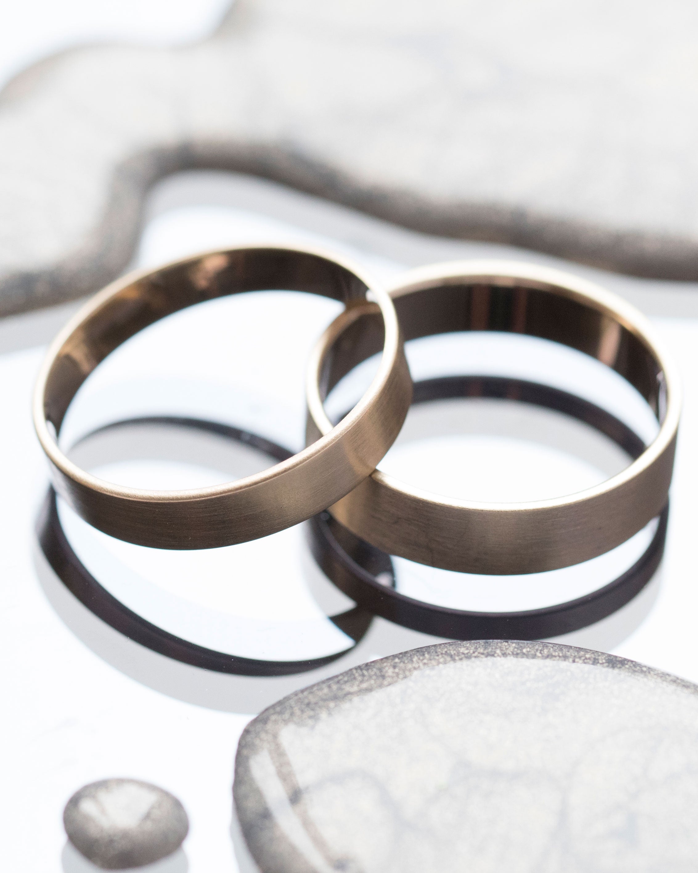 Elegant display of the Trusted III Band by Bliss Lau, featuring two beautifully crafted rings with a subtle matte finish, perfect for a luxury accessory that embodies simplicity and symmetry.