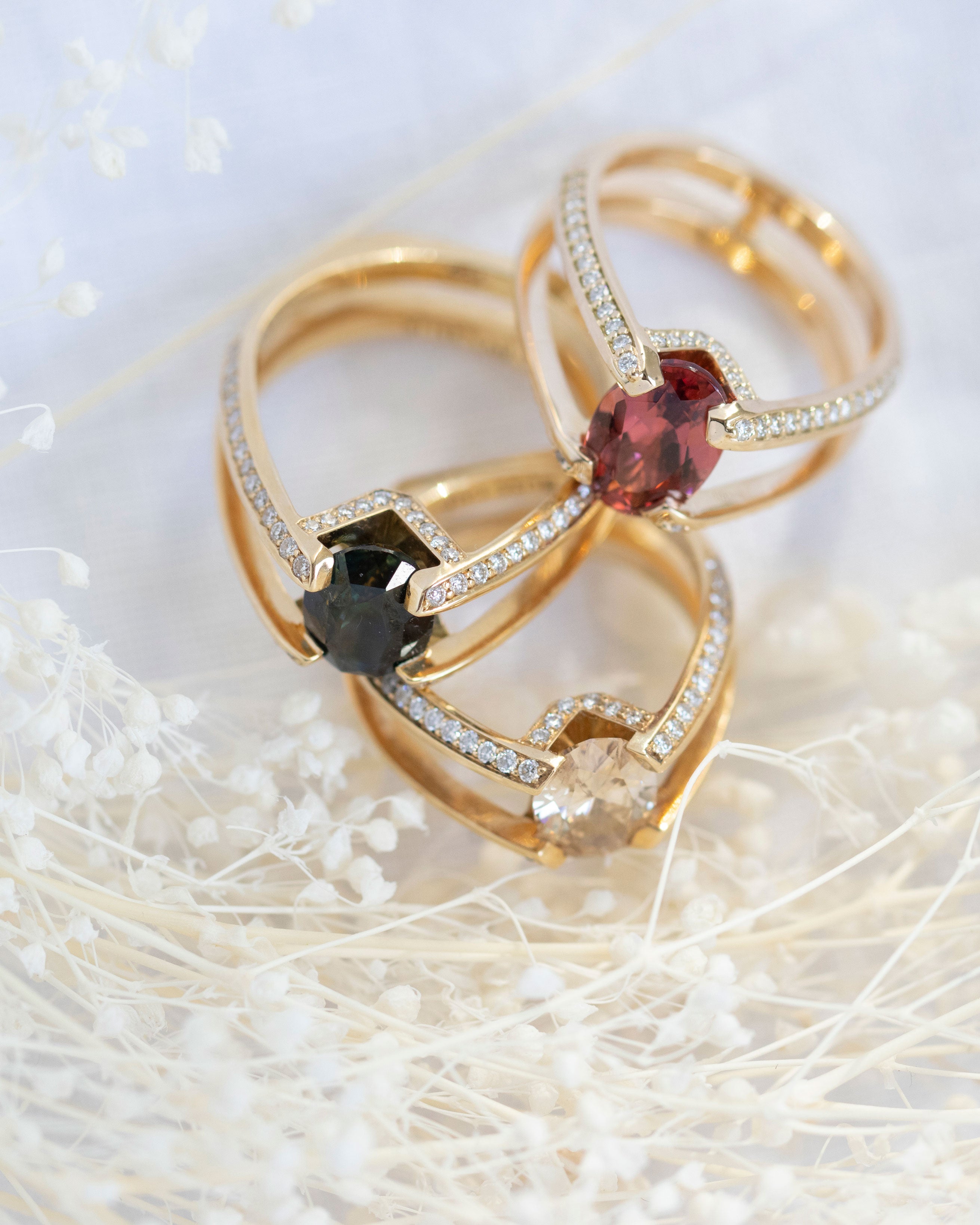 Futurist Engagement Ring Signature Collection highlighting a trio of stunning rings with multi-colored gemstones and a brilliant white diamond pave setting, a perfect choice for a sophisticated engagement.