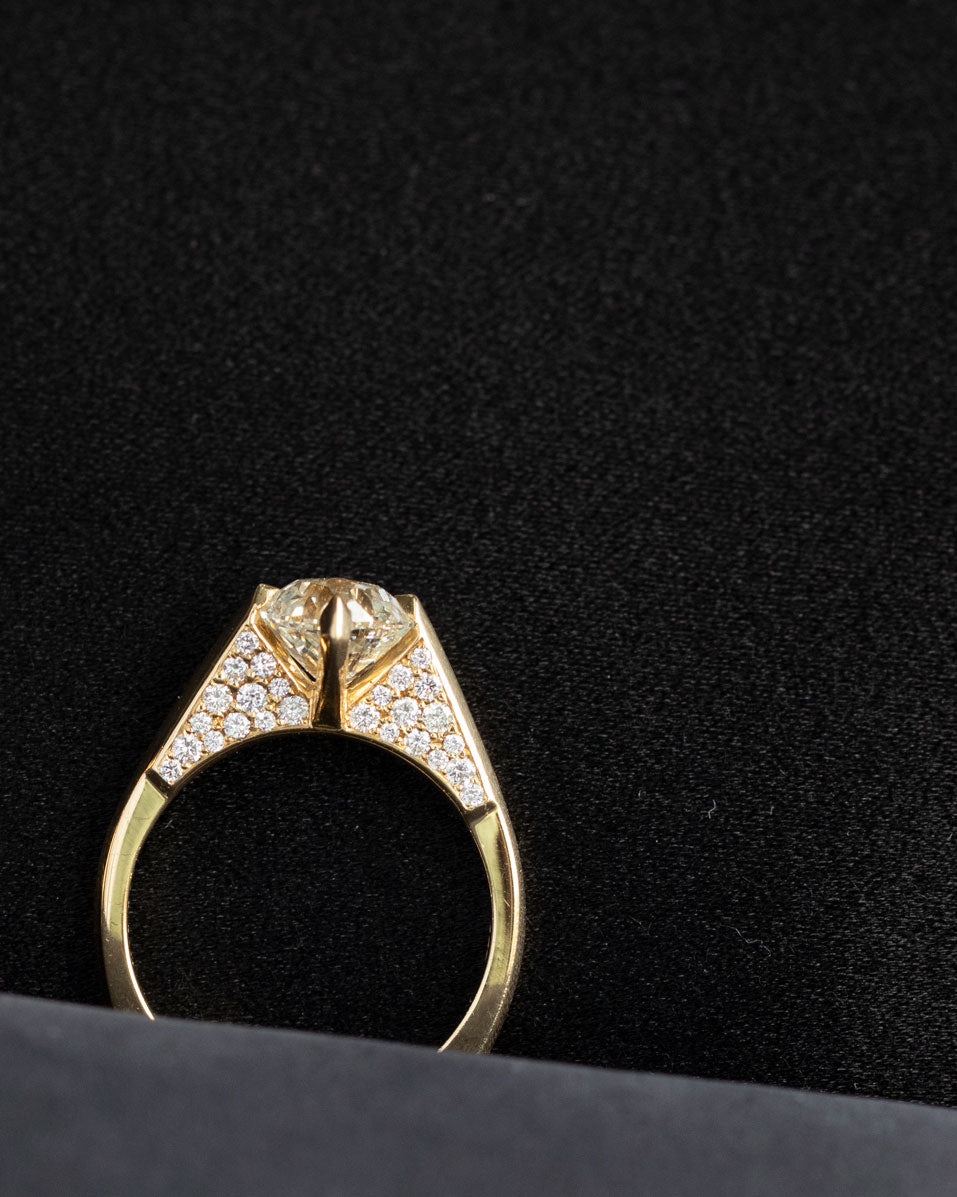 A refined minimalist gold ring placed elegantly, reflecting the creative elements of the minimalist arc, minimalist rise, and minimalist pave series by Bliss Lau.