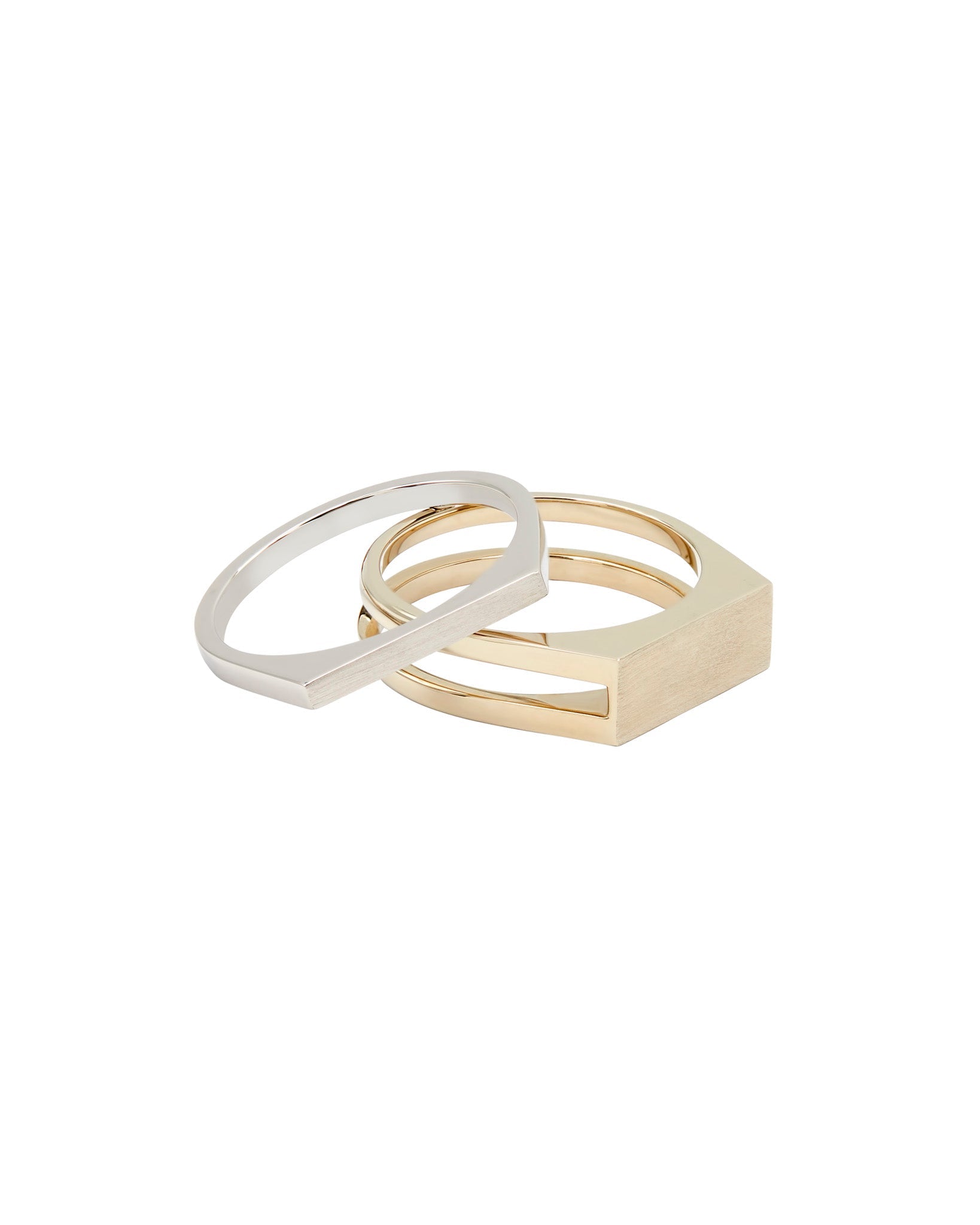 Cohesive Ring Set featuring an interlocking design with a natural white gold band and a solid platinum ring, symbolizing connection and inner strength.