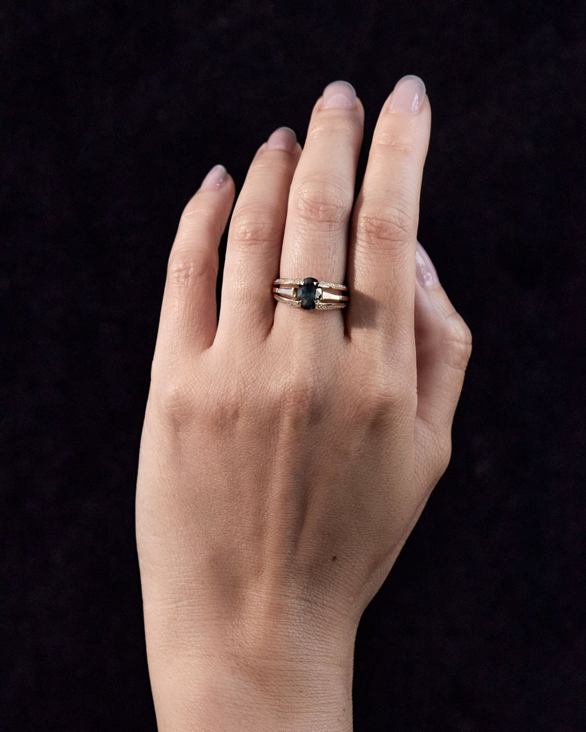 deep blue sapphire engagement ring on hand