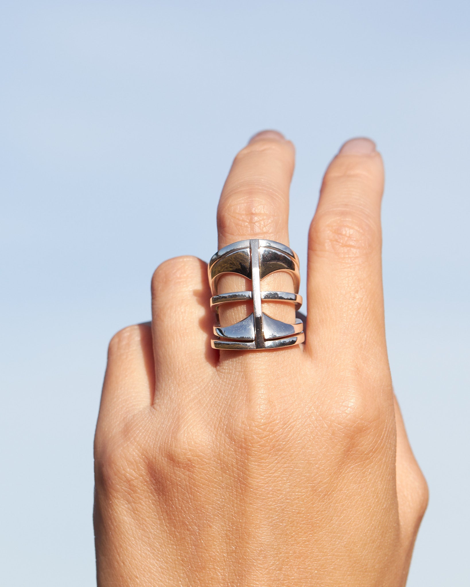 Model showcasing the Kaleidoscope ring set on their fingers, highlighting the rings' unique designs and shiny finish.