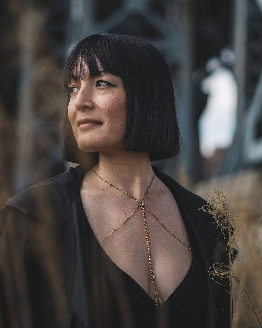 Model wearing the Visceral Body Chain from the Mysterious Concealment Collection in an outdoor setting, highlighting the chain's elegant and sensual aesthetic.