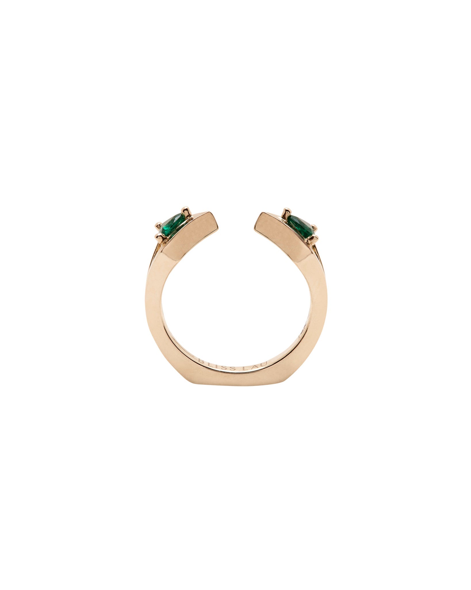 Chic Reflection Gold Wedding Bands Interlocking Ring Set showcasing exquisite green gemstones from a side view.