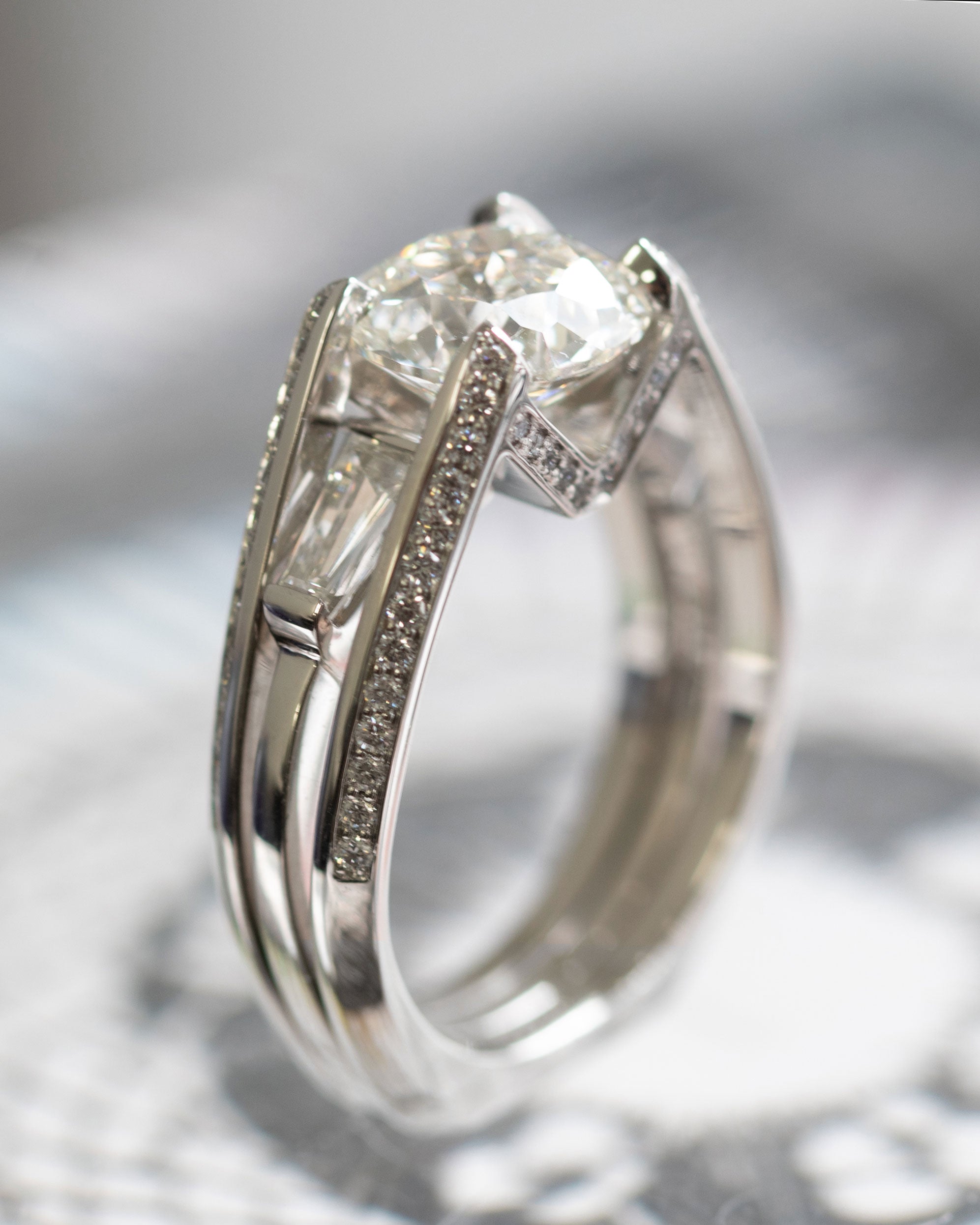 Side view of the Futurist Engagement Ring Signature Collection, featuring a luxurious arrangement of diamonds in a modern double band design.