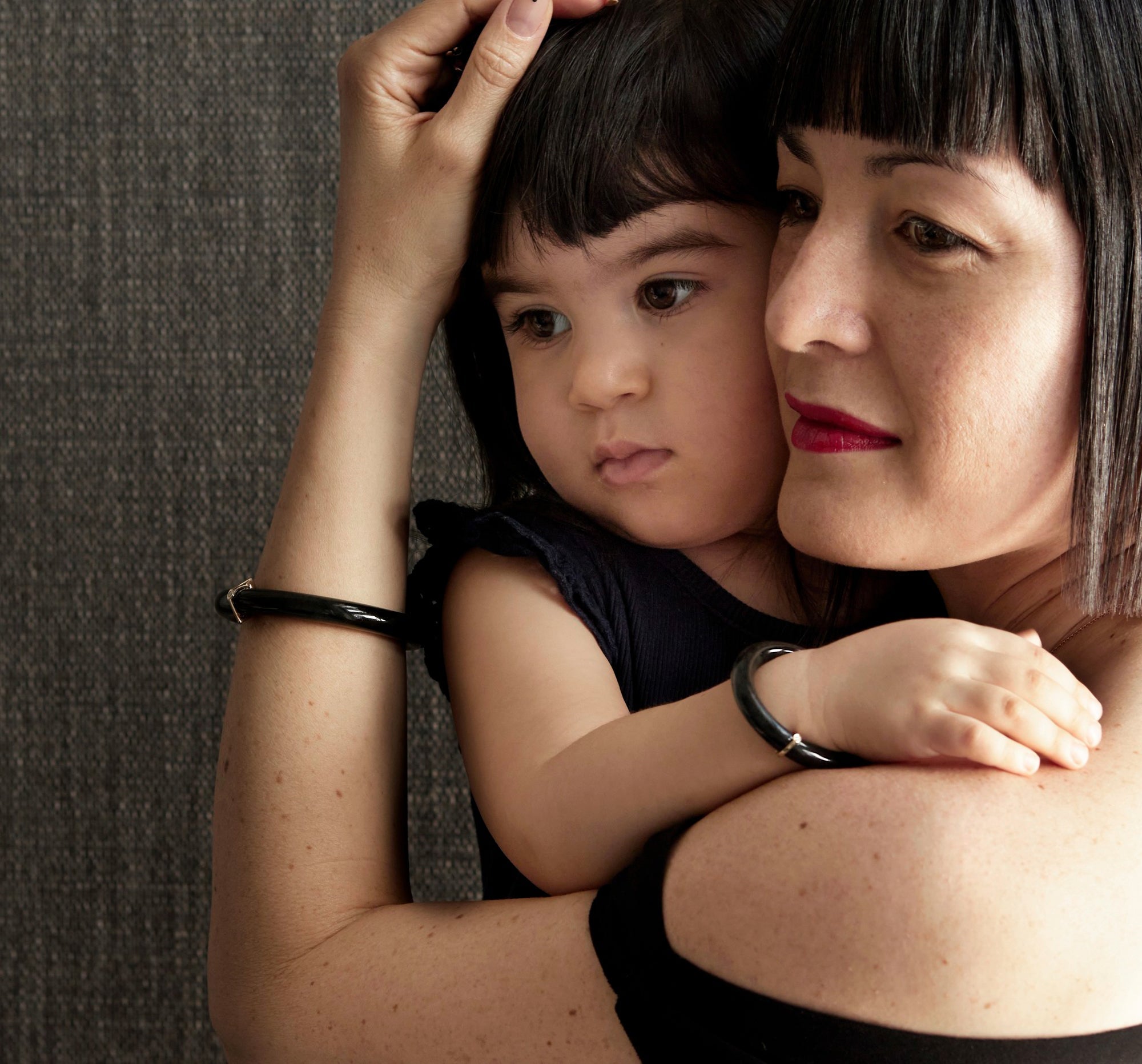 bliss and her daughter soa sharing a hug and matching jade bracelet
