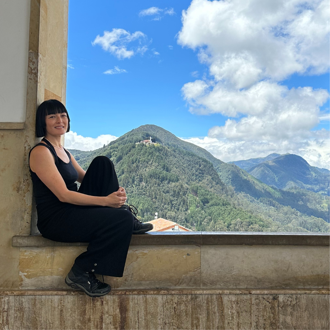 Bliss Lau overlooking the colombian mountains while visiting a fairmined gold mine