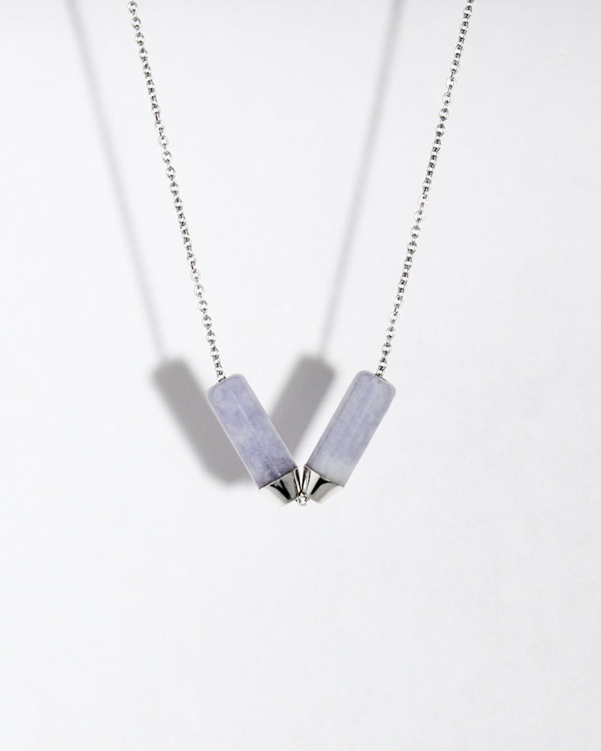 Platinum chain necklace with cylindrical lavender jade pieces on a white background