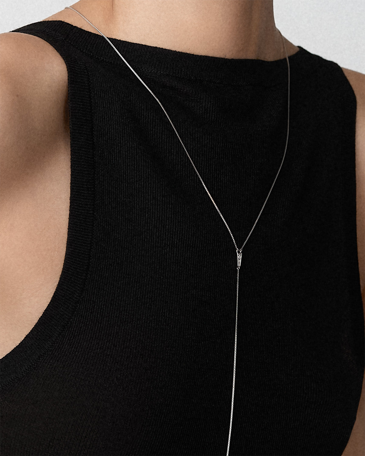 A close-up of a model wearing a Bliss Lau sterling silver Blink body chain