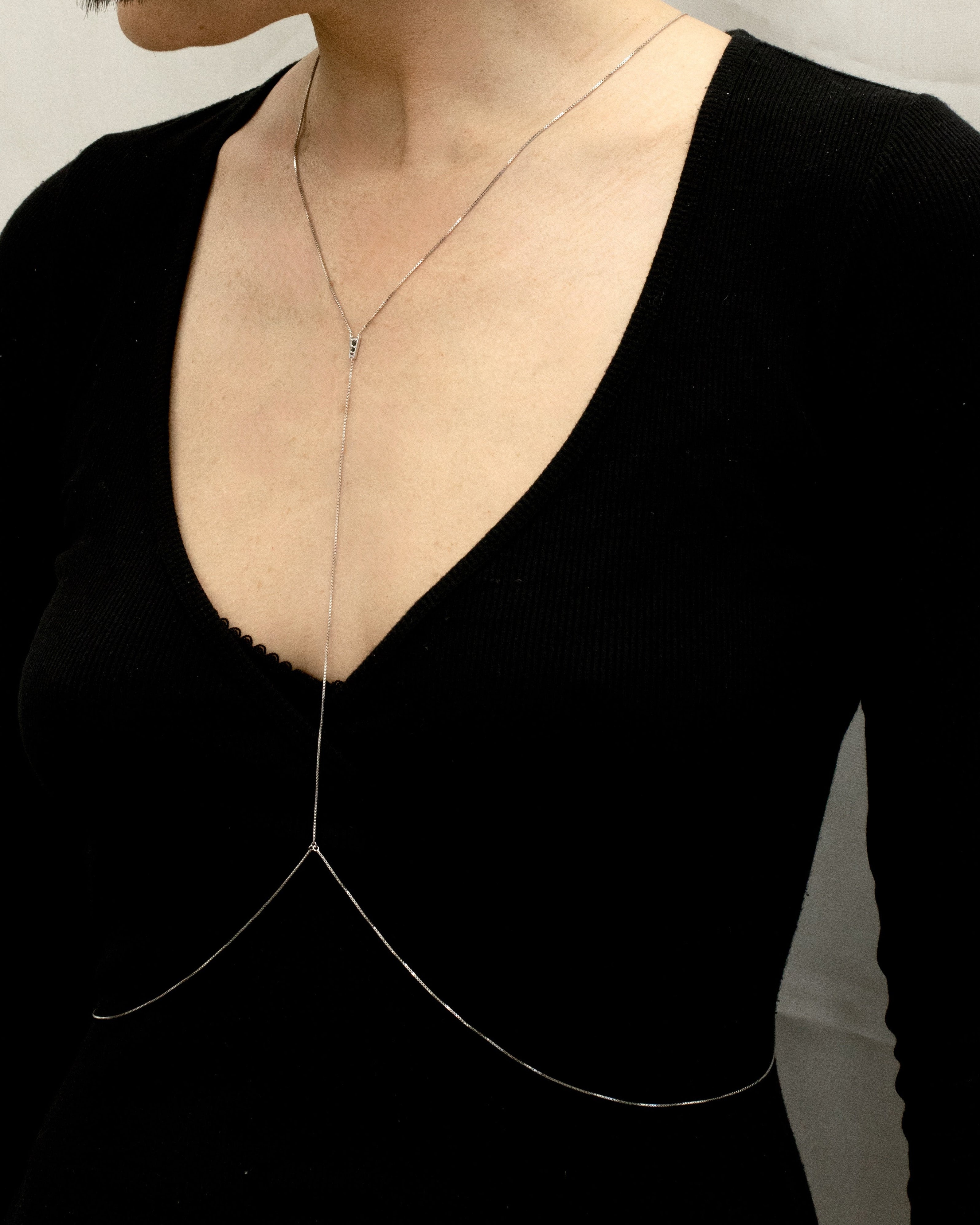 silver bodychain worn on the body, front view