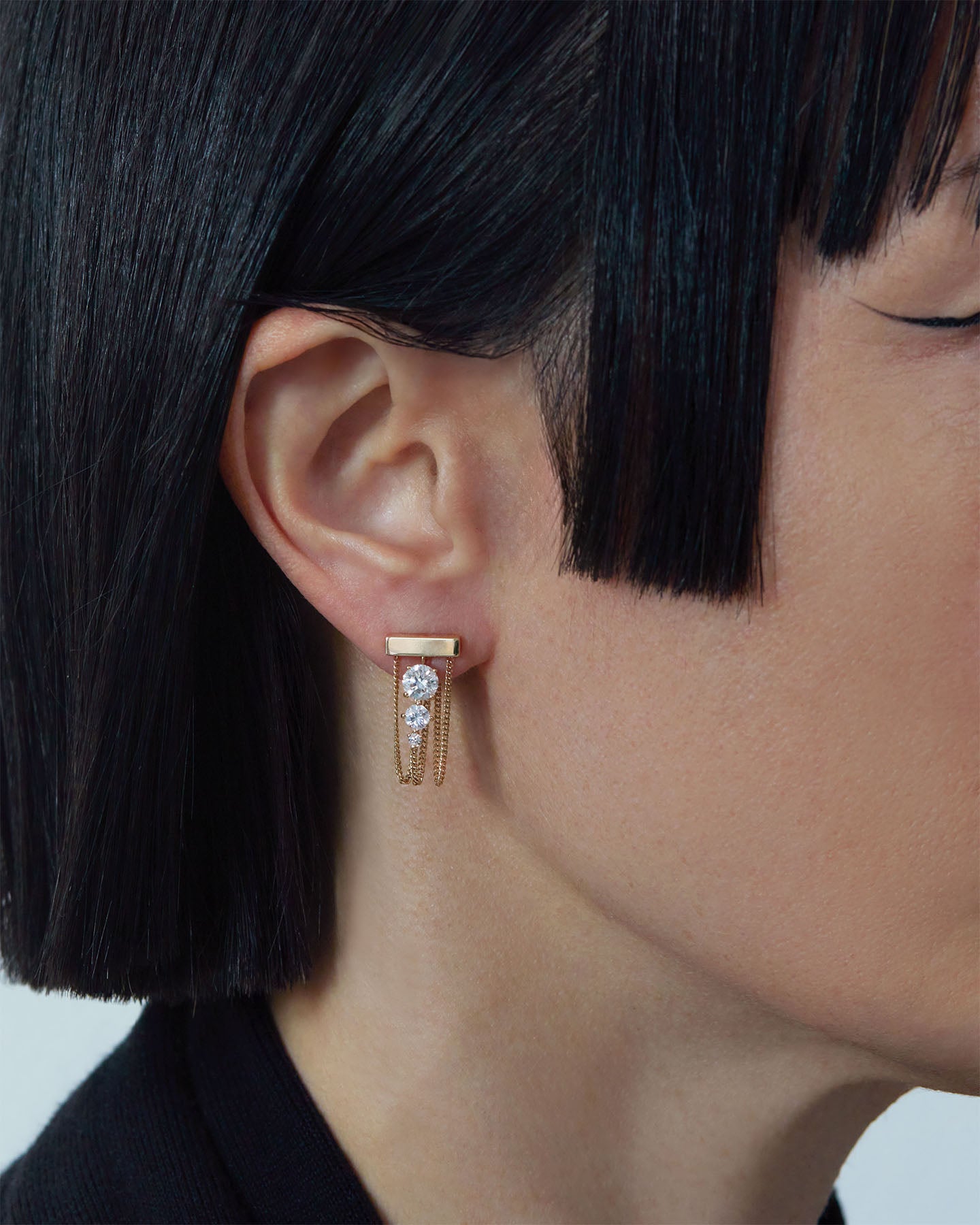 Luxury Levitate Diamond Trio Earrings featuring three certified Lab diamonds showcased on an elegant model, highlighting its unique design inspired by Olafur Eliasson's New York City Waterfalls.