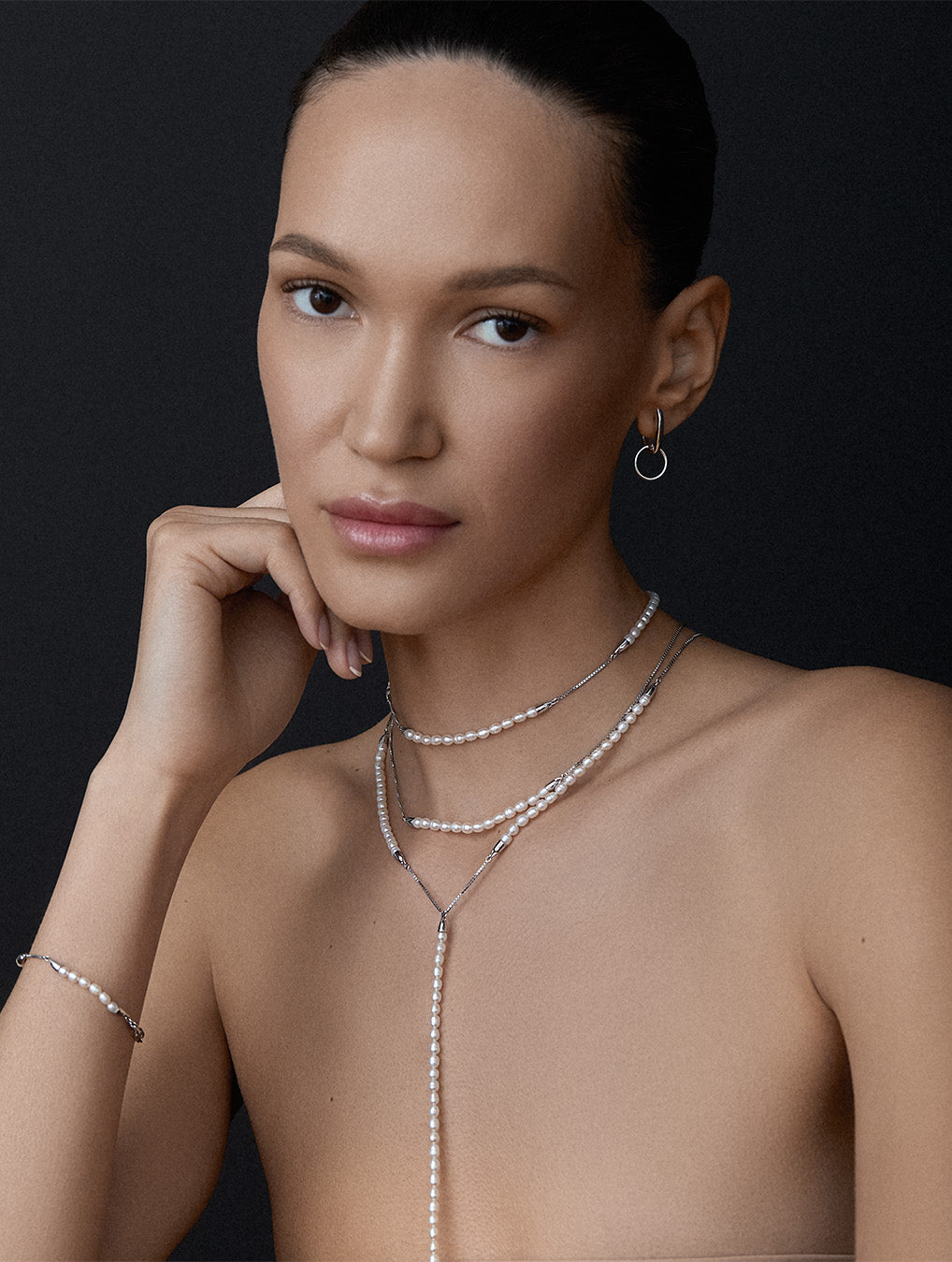 BLiss Lau Meridian pearl and sterling silver body chain, necklace and bracelet on a woman on a dark background