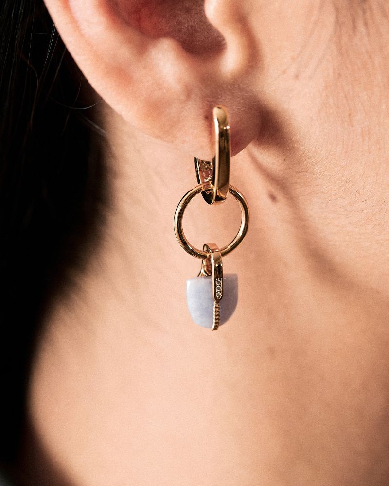 Close up of ear, with model wearing lavender jade pendant together with the nuance hoop huggie earring in 18k Gold