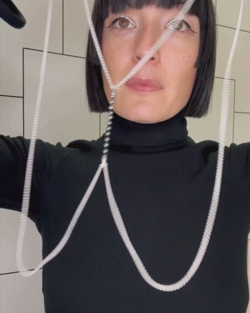 Video of Bliss Lau putting on the body chain