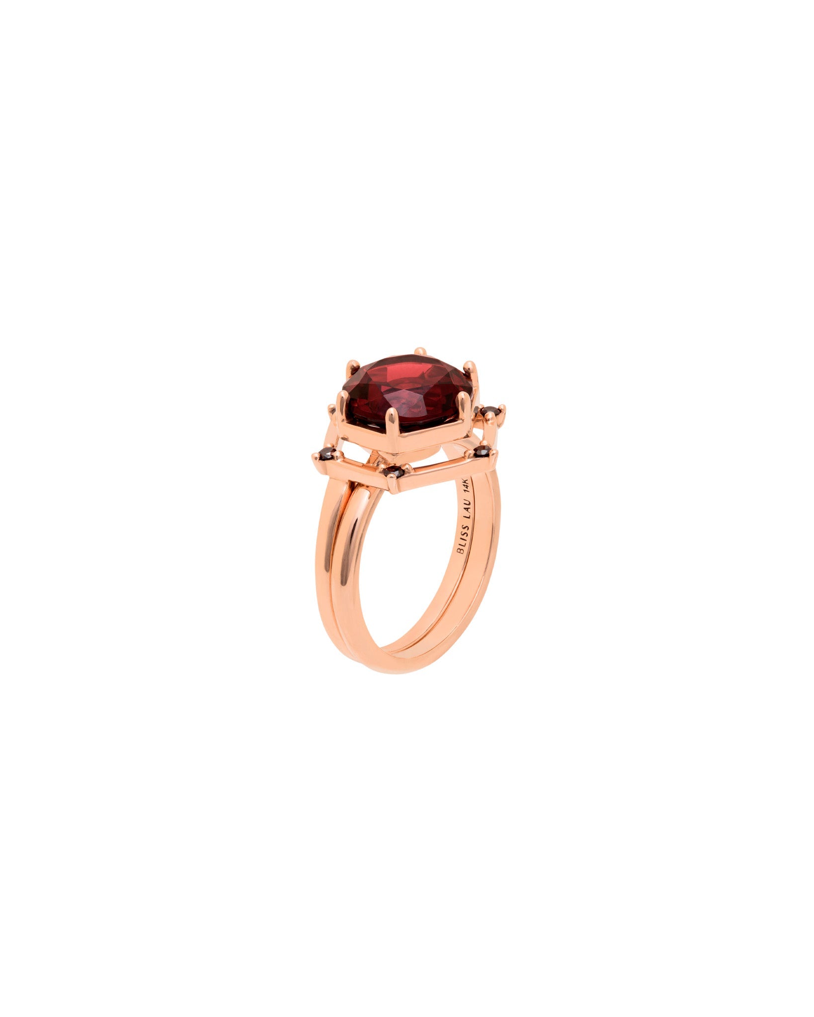 Bliss Lau interlocking ring with a red garnet center stone circled by black diamonds