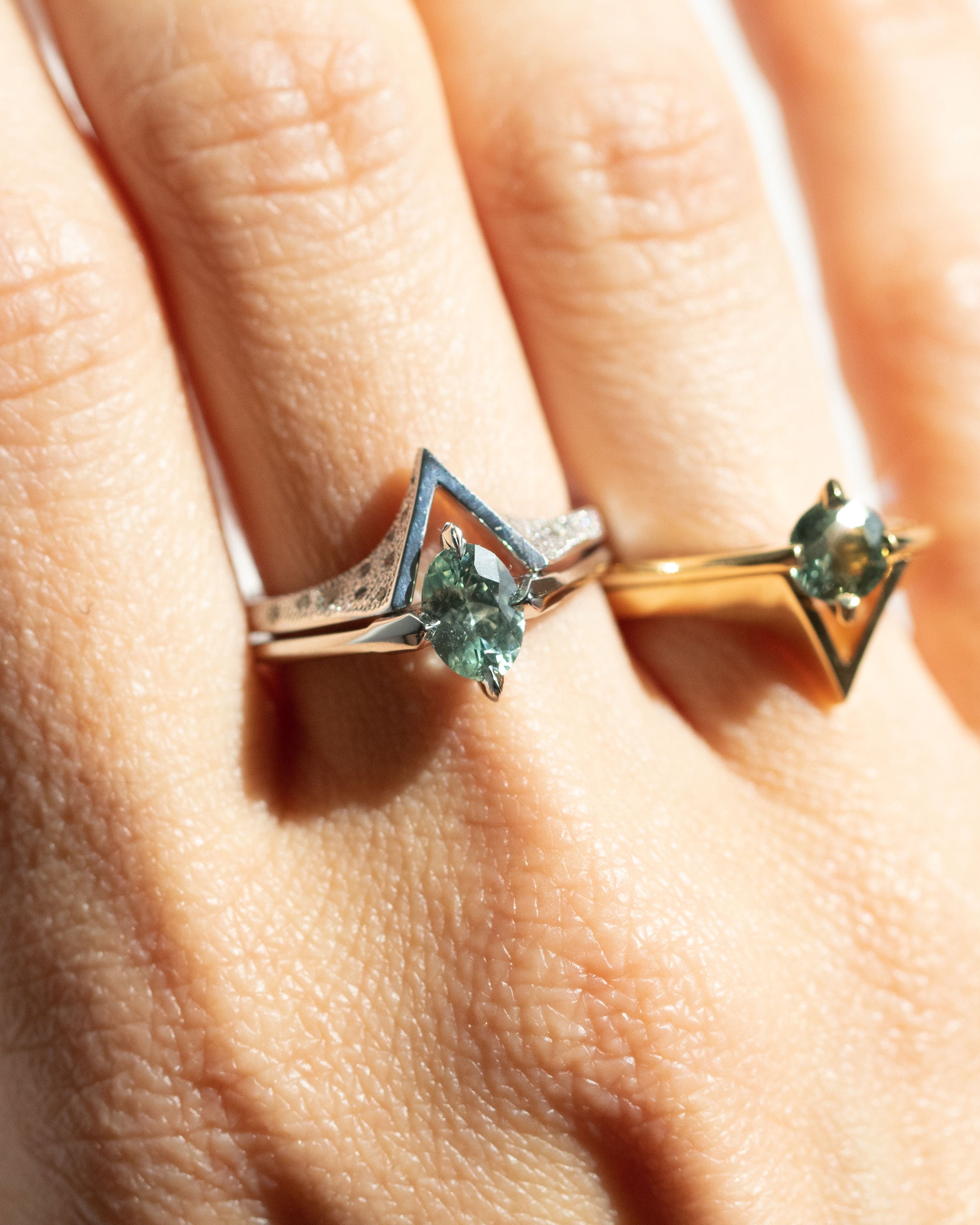 Elegant Spire Band rings displayed on a hand, showcasing their unique architectural design with geometric angles and exquisite detailing, perfect for stylish stacking or as a standalone statement piece.