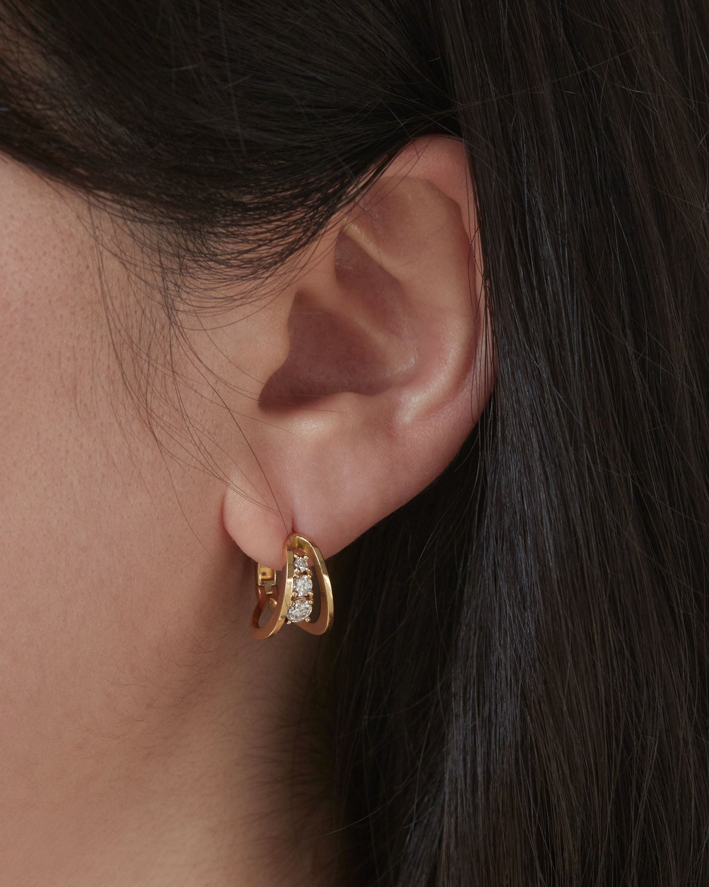SIngle earring on ear empath earrings lab diamonds and fairmined gold. 